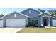Charming single-story home featuring a well-manicured lawn and a two-car garage at 8004 Juniper Rd, Ocala, FL 34480