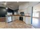 Modern kitchen with white cabinets, tile floors, and stainless steel appliances at 8004 Juniper Rd, Ocala, FL 34480