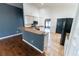 Open kitchen featuring a bar countertop, white cabinets and stainless appliances at 8004 Juniper Rd, Ocala, FL 34480