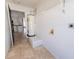 Practical laundry room with storage shelves and water heater, located next to the kitchen at 8004 Juniper Rd, Ocala, FL 34480
