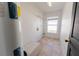 A functional laundry room featuring tile flooring, window and space for appliances at 8004 Juniper Rd, Ocala, FL 34480