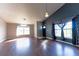Open living room featuring neutral wall paint, hardwood floors, and a pendant lamp at 8004 Juniper Rd, Ocala, FL 34480