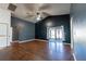 Spacious living room featuring a ceiling fan, access to the lanai, and hardwood flooring at 8004 Juniper Rd, Ocala, FL 34480
