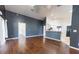 Open-concept living room featuring hardwood floors, high ceilings, and stylish wall color at 8004 Juniper Rd, Ocala, FL 34480