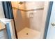 Bright shower with tiled walls, shower caddy, shower head, and a black shower curtain at 8004 Juniper Rd, Ocala, FL 34480