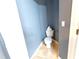 Cozy toilet room featuring light blue walls and neutral tile floors at 8004 Juniper Rd, Ocala, FL 34480