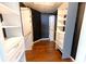 Walk-in closet with custom shelves and drawers, accented by dark walls and wood floors at 8004 Juniper Rd, Ocala, FL 34480