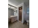 Bathroom featuring a single sink vanity, shower, and neutral tile flooring at 8045 Sw 108Th Loop, Ocala, FL 34481