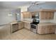 A well-lit kitchen featuring stainless steel appliances and ample counter space at 8045 Sw 108Th Loop, Ocala, FL 34481