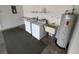 Well-equipped laundry area includes washer, dryer, utility sink, and water heater for added convenience at 8045 Sw 108Th Loop, Ocala, FL 34481