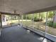 Enjoy the outdoors bug-free in this screened porch with ceiling fan and verdant backyard views at 8045 Sw 108Th Loop, Ocala, FL 34481