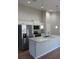 This open kitchen boasts stainless steel appliances, granite countertops, and sleek pendant lighting at 8661 Juniper Rd, Ocala, FL 34480