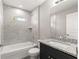 Well-lit bathroom with shower-tub combo and updated fixtures at 87 Guava Pass Dr, Ocklawaha, FL 32179