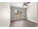 Bedroom featuring a bright window, neutral walls, and wood floors at 87 Guava Pass Dr, Ocklawaha, FL 32179