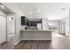 Modern kitchen featuring granite countertops, stainless steel appliances, and a breakfast bar at 87 Guava Pass Dr, Ocklawaha, FL 32179
