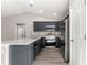 Modern kitchen featuring granite countertops, stainless steel appliances, and dark cabinetry at 87 Guava Pass Dr, Ocklawaha, FL 32179