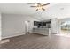 Open-concept kitchen featuring granite countertops, stainless steel appliances, and dark cabinetry at 87 Guava Pass Dr, Ocklawaha, FL 32179