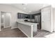 Stylish kitchen with granite countertops, stainless steel appliances, and dark cabinets at 87 Guava Pass Dr, Ocklawaha, FL 32179
