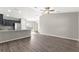 Open-concept living room featuring vaulted ceilings, modern ceiling fan, and wood-look flooring at 87 Guava Pass Dr, Ocklawaha, FL 32179
