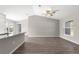 Open-concept living area with kitchen island, modern floors, and plenty of light at 87 Guava Pass Dr, Ocklawaha, FL 32179