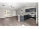 Living room and kitchen combination featuring wood-look flooring, and stainless steel appliances at 87 Guava Pass Dr, Ocklawaha, FL 32179