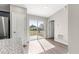 Sunlit living room with modern gray walls and sliding glass doors to the backyard at 87 Guava Pass Dr, Ocklawaha, FL 32179