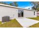 Home exterior featuring a patio and sliding glass doors at 87 Guava Pass Dr, Ocklawaha, FL 32179
