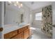 Bright bathroom featuring a vanity, toilet, and shower-tub combo at 8895 Sw 57Th Court Rd, Ocala, FL 34476