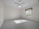 Bright, carpeted bedroom with a ceiling fan and window at 8895 Sw 57Th Court Rd, Ocala, FL 34476