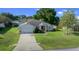 Traditional single-story home featuring an attached garage and well-maintained lawn at 8895 Sw 57Th Court Rd, Ocala, FL 34476