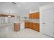 Bright kitchen featuring wood cabinets, a breakfast bar, and tile floors at 8895 Sw 57Th Court Rd, Ocala, FL 34476