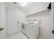 Clean laundry room featuring modern appliances and a storage shelf at 8895 Sw 57Th Court Rd, Ocala, FL 34476
