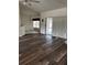 Spacious living room featuring sleek wood flooring, a sliding glass door, and ample natural light at 8895 Sw 57Th Ct Rd, Ocala, FL 34476