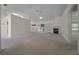 Open-concept living room with neutral carpeting and a fireplace at 8895 Sw 57Th Court Rd, Ocala, FL 34476