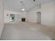 Bright living room featuring a fireplace, ceiling fan, and sliding glass doors at 8895 Sw 57Th Court Rd, Ocala, FL 34476