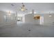 Open concept living area with tile floors and a view of the front entry and kitchen at 8895 Sw 57Th Court Rd, Ocala, FL 34476