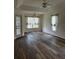Living room features two ceiling fans, new flooring, and multiple windows at 8895 Sw 57Th Ct Rd, Ocala, FL 34476