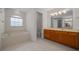 Bright main bathroom featuring a soaking tub, window, and wood vanity with a large mirror at 8895 Sw 57Th Court Rd, Ocala, FL 34476