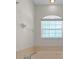 Close up of a soaking tub with jets below an arched window in the main bath at 8895 Sw 57Th Court Rd, Ocala, FL 34476