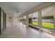 Bright sunroom with large windows offering views of the landscaped backyard at 8895 Sw 57Th Court Rd, Ocala, FL 34476