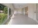 Enclosed sunroom with tile flooring and multiple windows, offering bright natural light at 8895 Sw 57Th Court Rd, Ocala, FL 34476