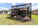 Exterior view of screened-in patio and manicured backyard, perfect for relaxation and outdoor living at 8951 Sw 58Th Street Rd, Ocala, FL 34481