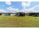 Wide shot of the backyard showcasing the screened-in patio attached to the house at 8951 Sw 58Th Street Rd, Ocala, FL 34481