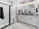 Modern bathroom features a glass-enclosed shower, dual sinks, and sleek, contemporary fixtures at 8951 Sw 58Th Street Rd, Ocala, FL 34481
