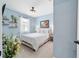 Airy bedroom with light blue walls, nautical decor and plush white bedding at 8951 Sw 58Th Street Rd, Ocala, FL 34481