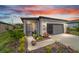 Charming single-story home with a landscaped front yard and cozy porch at sunset at 8951 Sw 58Th Street Rd, Ocala, FL 34481