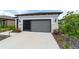 Exterior of home showing driveway, garage and screen enclosed porch at 8951 Sw 58Th Street Rd, Ocala, FL 34481