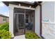 Cozy screened-in front porch with seating, a welcoming entrance, and stone accents at 8951 Sw 58Th Street Rd, Ocala, FL 34481