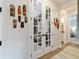 Hallway with decorative wall hangings leading to a study with glass french doors at 8951 Sw 58Th Street Rd, Ocala, FL 34481