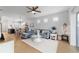 Bright living room featuring a comfortable blue sofa and open concept to the dining area at 8951 Sw 58Th Street Rd, Ocala, FL 34481